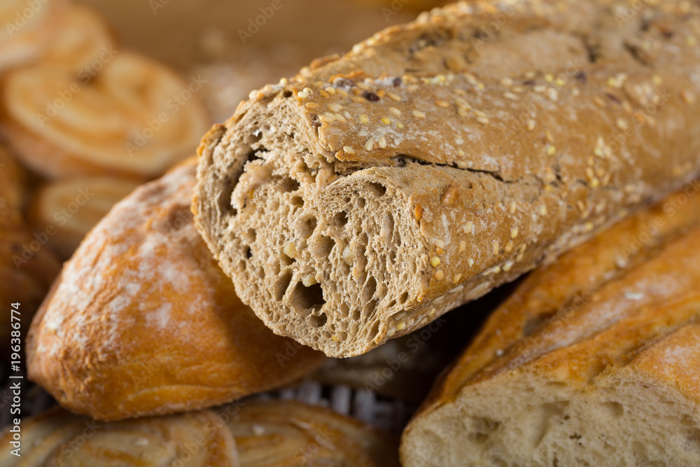 Cut wholegrain baguette with bakery products