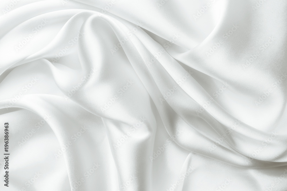 Elegant white satin silk with waves, abstract background.