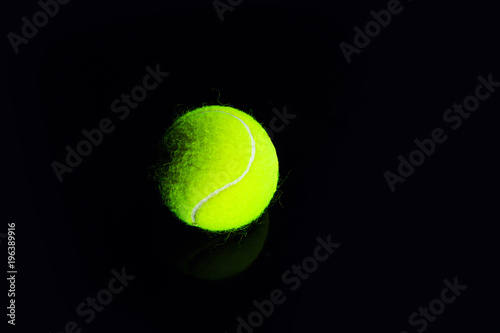 Tennis Ball isolated on black with dramatic lighting © The Len