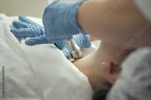 Cosmetology and professional skin care. Facial and skin care. The girl is doing Non-injection mesotherapy. The cosmetologist makes the procedure. 