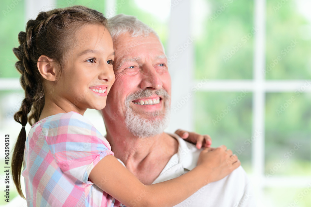 Fototapeta premium Grandfather with her granddaughter hugging 