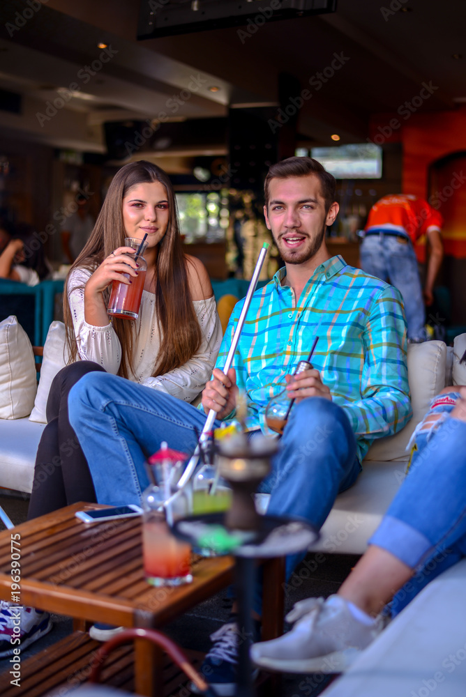 Frends hanging out and smooking hookah