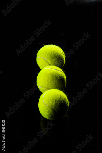 Tennis Ball isolated on black with dramatic lighting © The Len