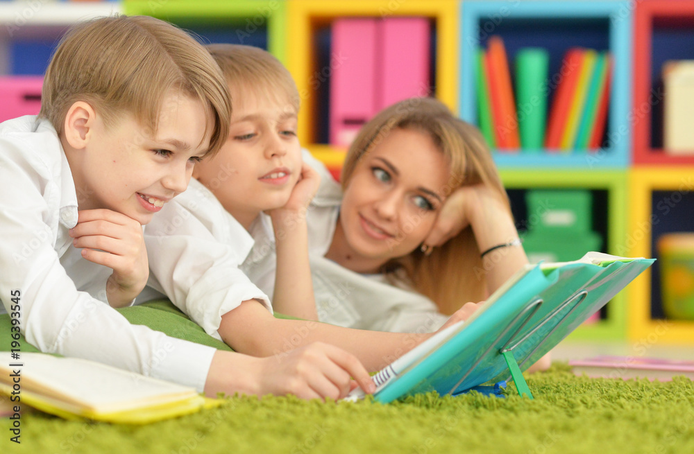 mother and sons doing homework mother and sons doing homework
