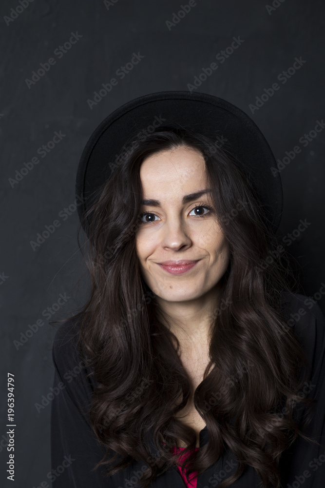 Happy tender girl. Photo of gorgeous young brunette woman in black hipster hat Happy tender girl. Photo of gorgeous young brunette woman in black hipster hat