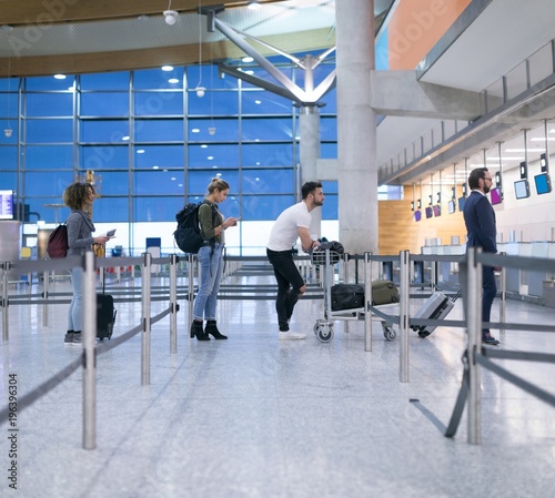 Commuters standing in queue for check-in photo