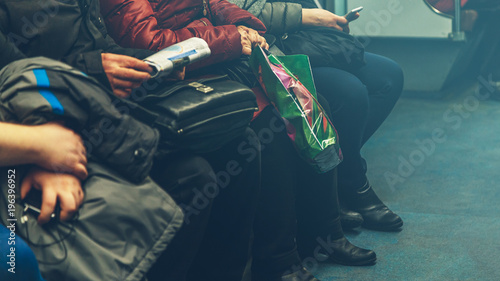 people are sitting in a subway train 