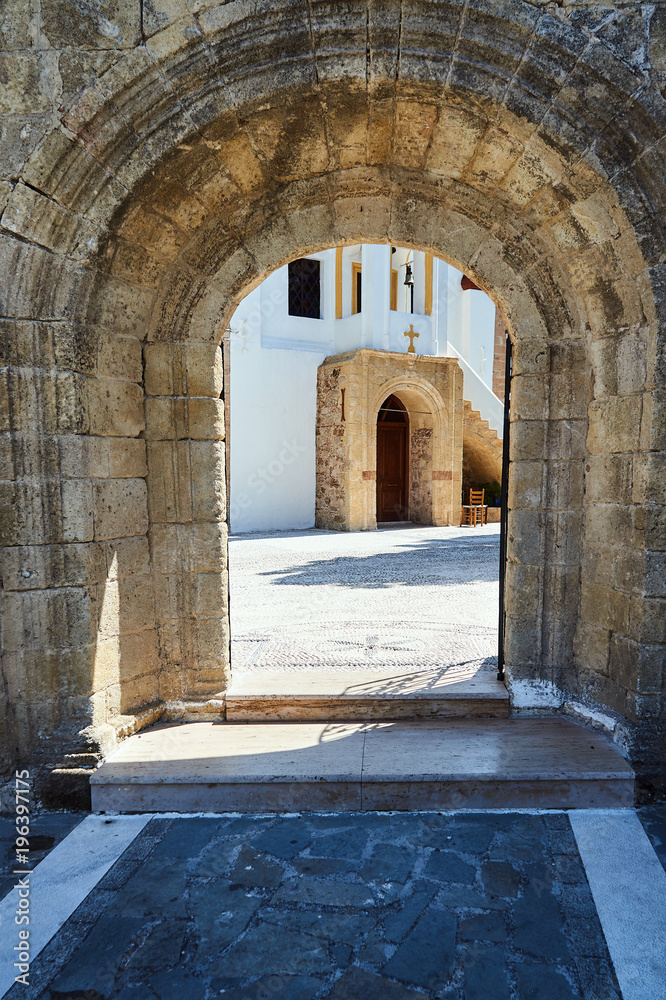 Stone portal and courtyard of the Orthodox monastery on the island of Rhodes.