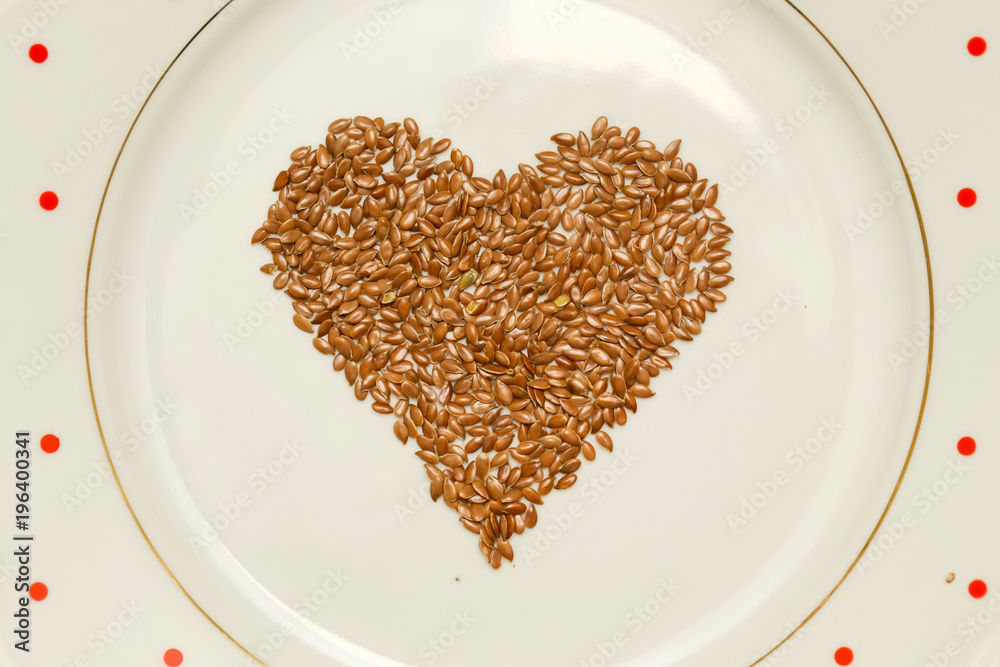 Heart shaped flax seeds in the plate Heart shaped flax seeds in the plate