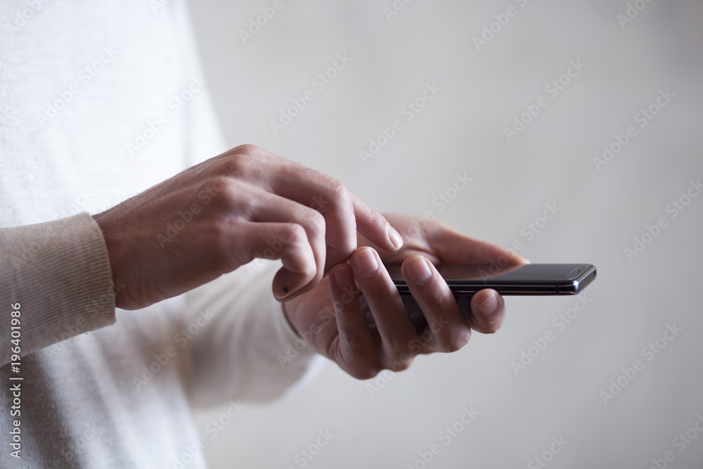 businessman hand phone on dark background