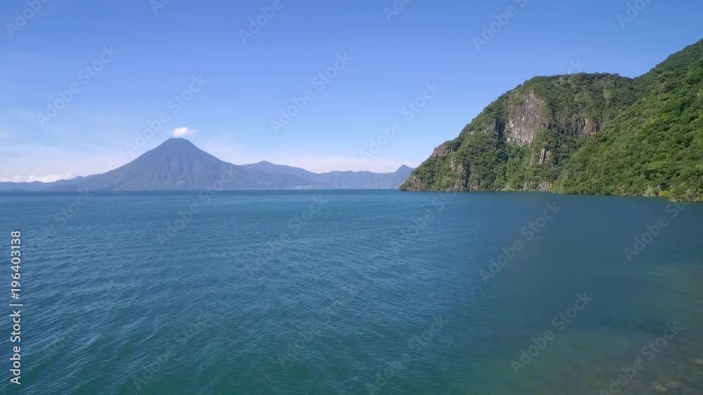 Aerial over Lake Amatitlan in Guatemala reveals the Pacaya Volcano in the distance. Aerial over Lake Amatitlan in Guatemala reveals the Pacaya Volcano in the distance.