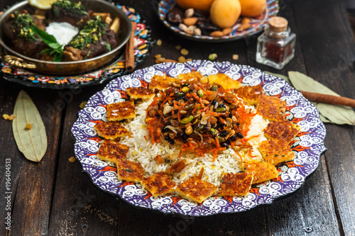 Delicious Iranian jewelled rice topped with nuts, raisins and orange zest photo