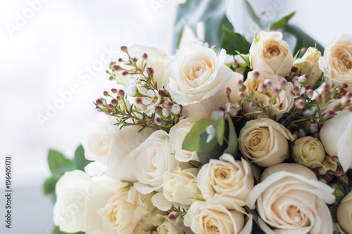 Tender beautiful wedding bouquet closeup, peach color roses and decoration, selective focus