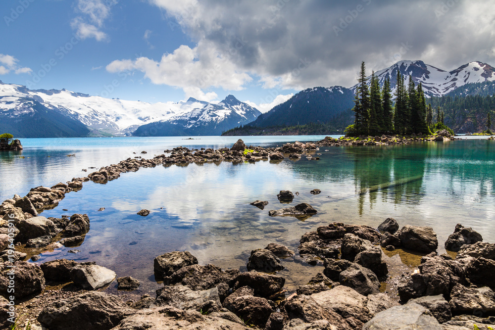 Blue and green reflections of trees and mountains, Garibaldi Lake,  BC