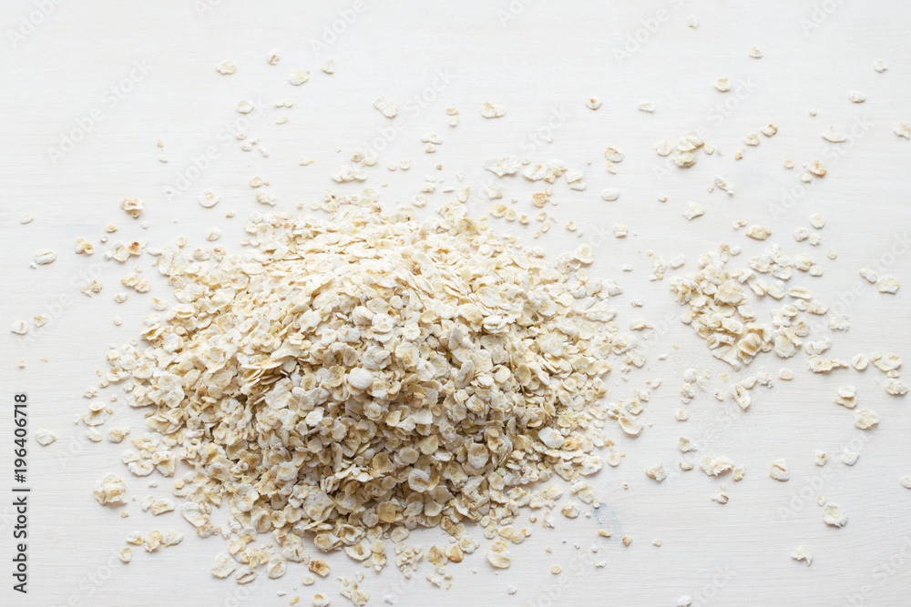 heap of rolled oats on a white background heap of rolled oats on a white background