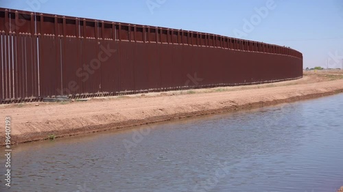 A tributary of the Colorado River flows along the border wall between the US and Mexico.