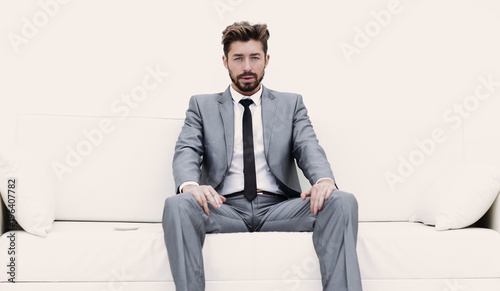 Successful businessman sitting in a suit smokes © ASDF