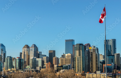 Calgary city skyline and pole with canadian flag