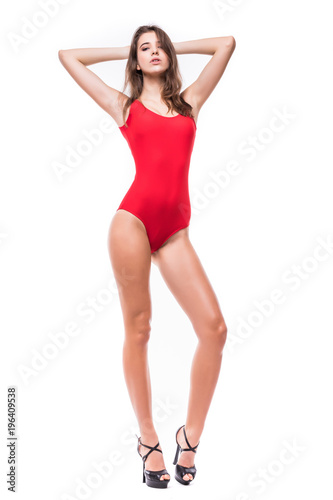 Full body attractive and beautiful woman in a red swimsuit standing on white background. Perfect body.