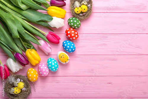 Easter eggs with colorful tulips on wooden background  easter holiday concept. Easter decor. 