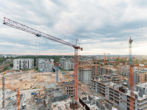 Aerial view of construction site with crane and building. Top view of big development construction and architecture.