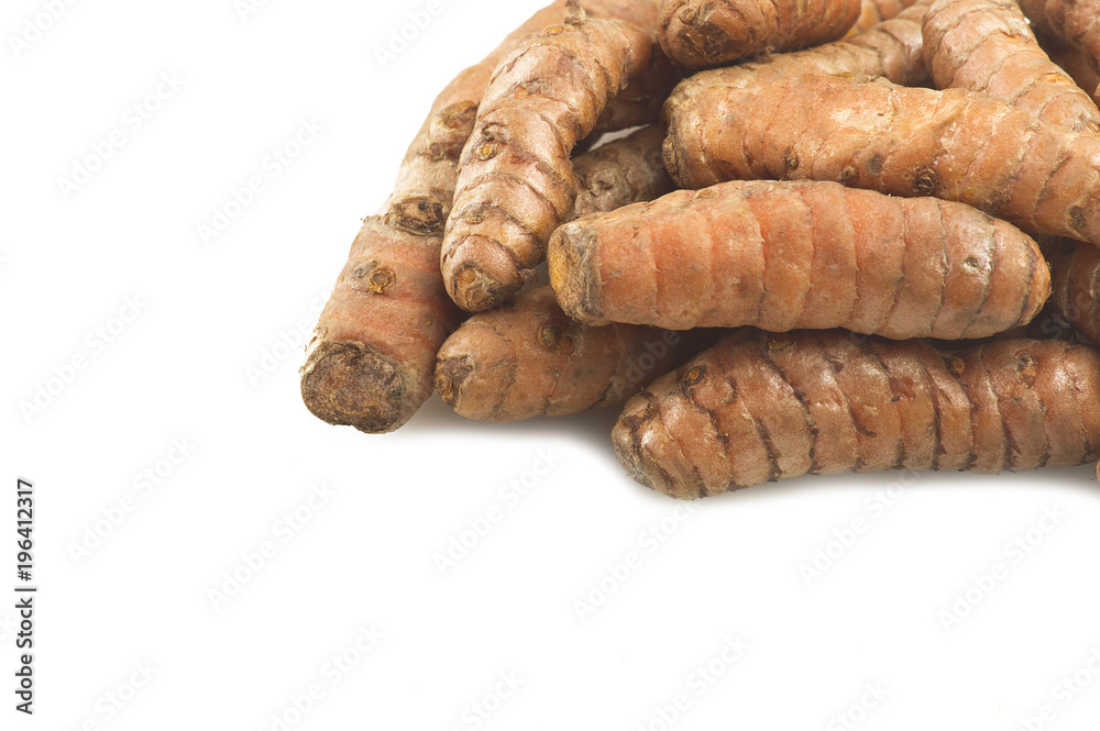 turmeric root and some slices on a white background turmeric root and some slices on a white background