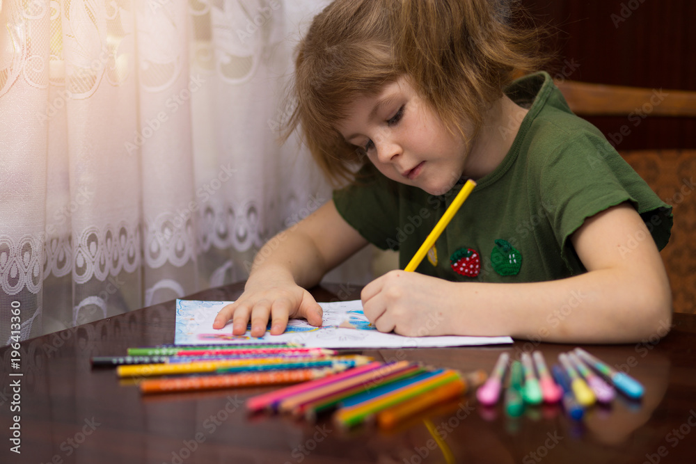 Cute portrait of little kid girl drawing by multi-colored pencils. concept of kids hobby or childhood, happy lifestyle Cute portrait of little kid girl drawing by multi-colored pencils. concept of kids hobby or childhood, happy lifestyle
