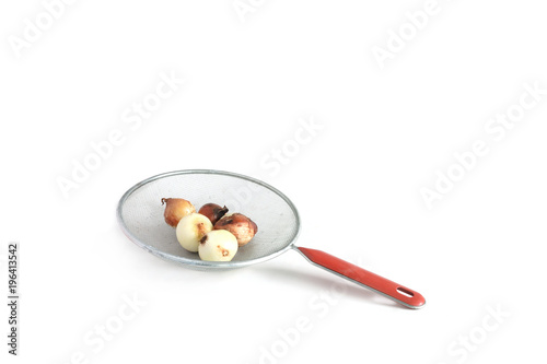 Colander with onion put  inside on white background. Equipment used in the kitchen.