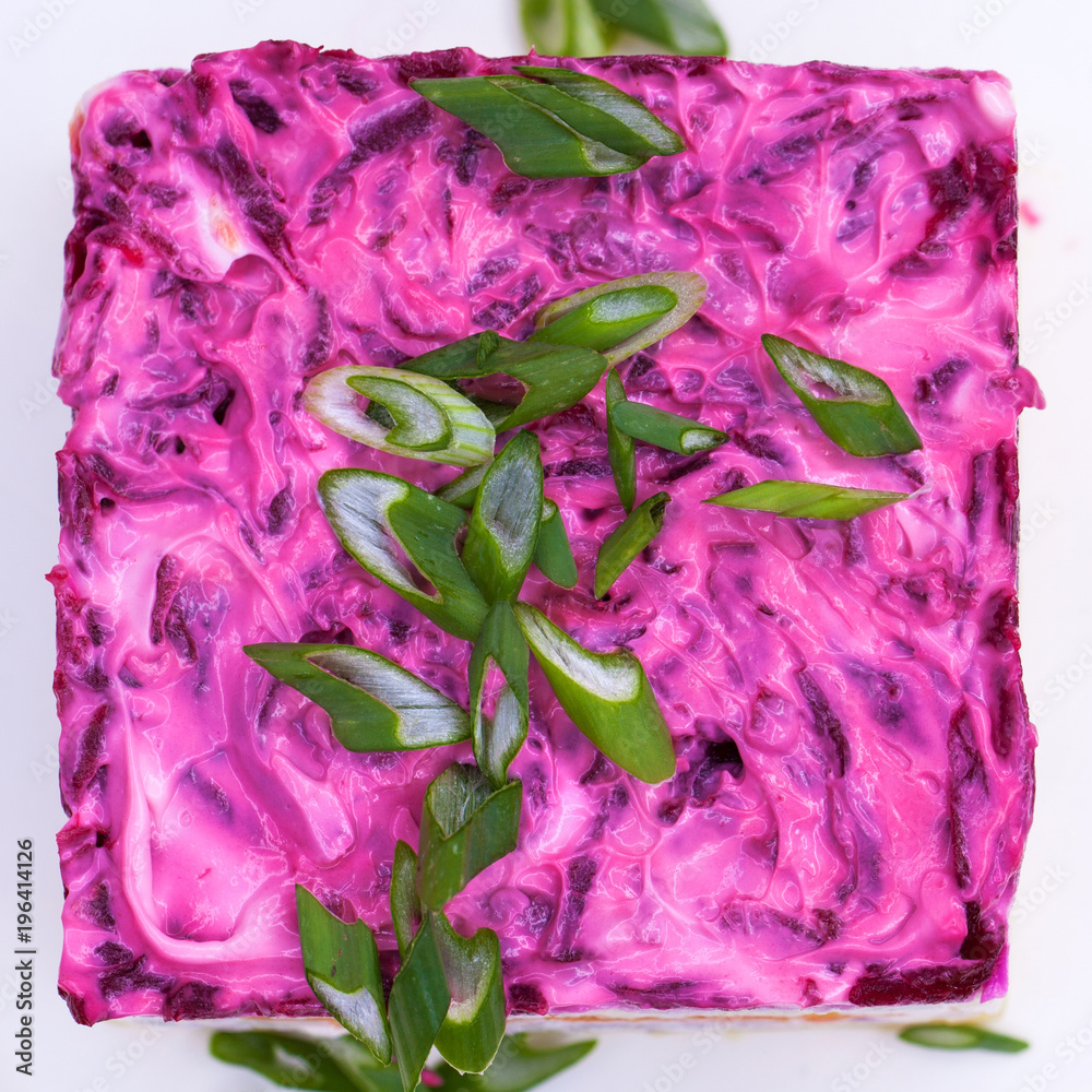 Russian food: holiday herring salad with vegetables close-up on the table Russian food: holiday herring salad with vegetables close-up on the table
