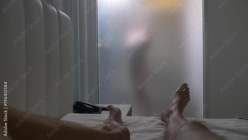 Woman behind blurry glass. Girl preparing take shower. Woman in bathroom. a man watches as a woman takes a shower through a glass wall in the shower. 4k Stock ビデオ | Adobe Stock