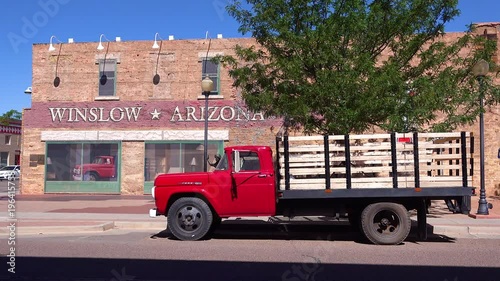 Establishing shot of downtown Winslow, Arizona with mural depicting a flatbed Ford on Route 66. photo