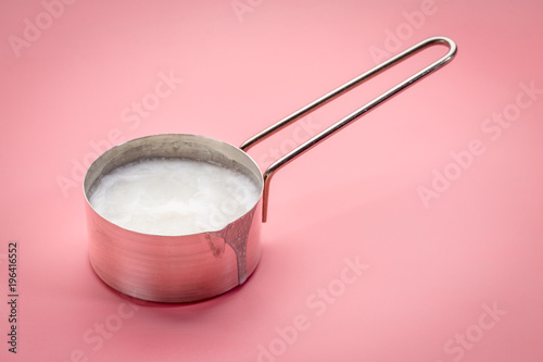 coconut cooking oil in a measuring scoop