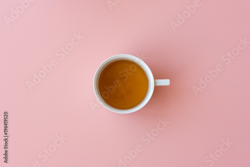 Directly above view of tea in cup on pink background