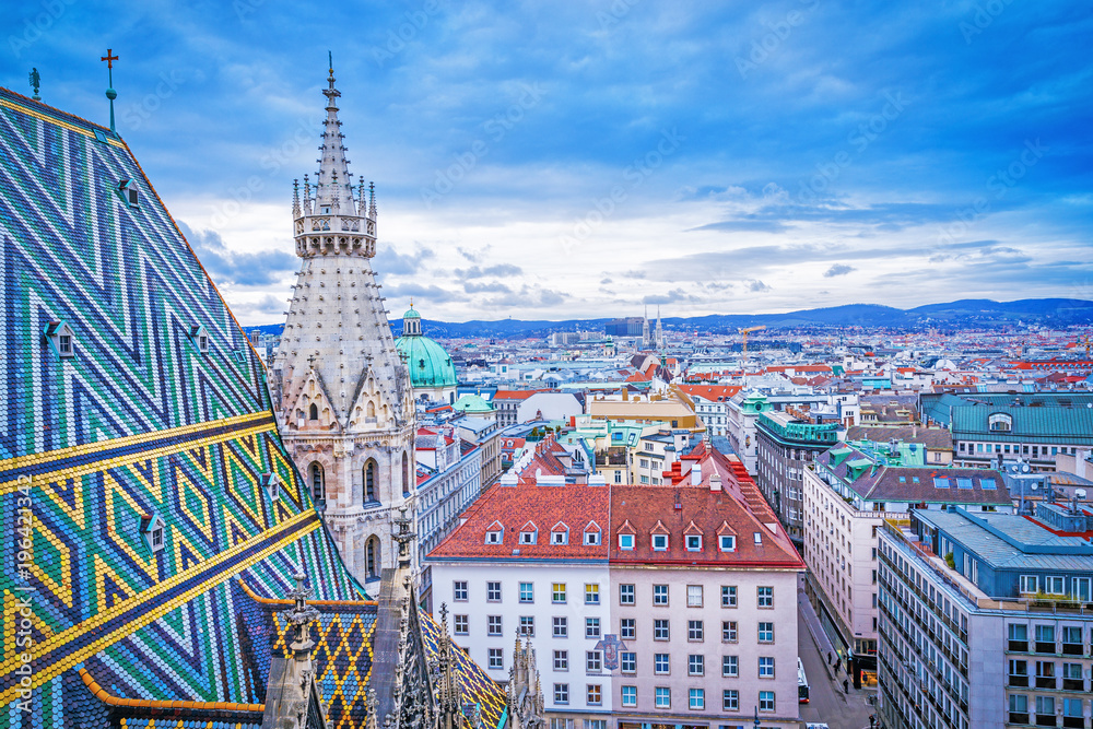 Fototapeta premium Lovely view from above of Vienna - the capital of Austria, European country. Iconic landmark and extremely popular European travel destination. View over roofs on classic architecture, day scenery.