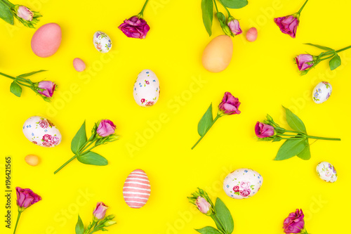 Happy Easter concept. Pattern colorful spring's flowers and colorful easter eggs on yellow background