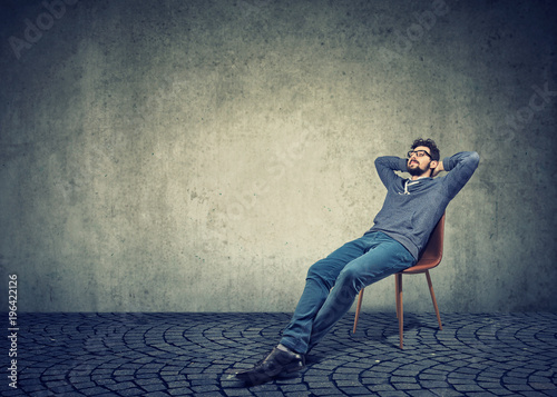 man sitting on chair and daydreaming photo