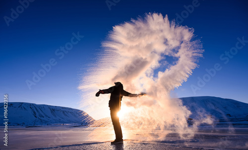 boiling water frost in polar arctic  sky  in Norway Svalbard in Longyearbyen  man mountains photo