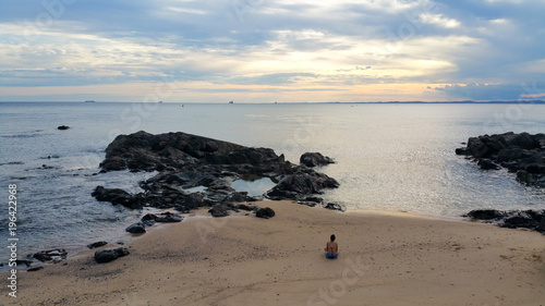 lonely girl sitting on the beach - loneliness
