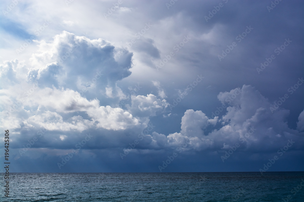 Obraz premium view from the shore to storm clouds over the sea