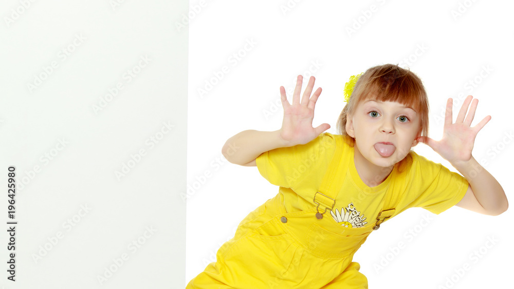 Girl with a short bangs on her head and bright yellow overalls. Girl with a short bangs on her head and bright yellow overalls.