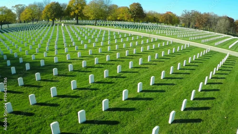 An aerial over a vast cemetery of headstones honors America's veterans.