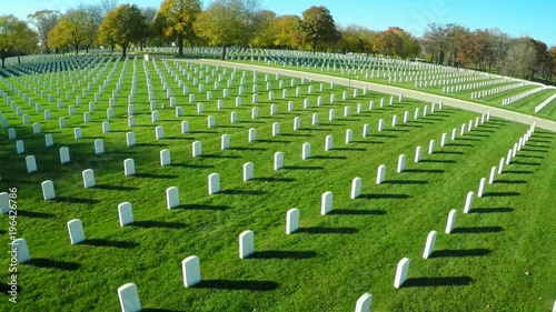 An aerial over a vast cemetery of headstones honors America's veterans.