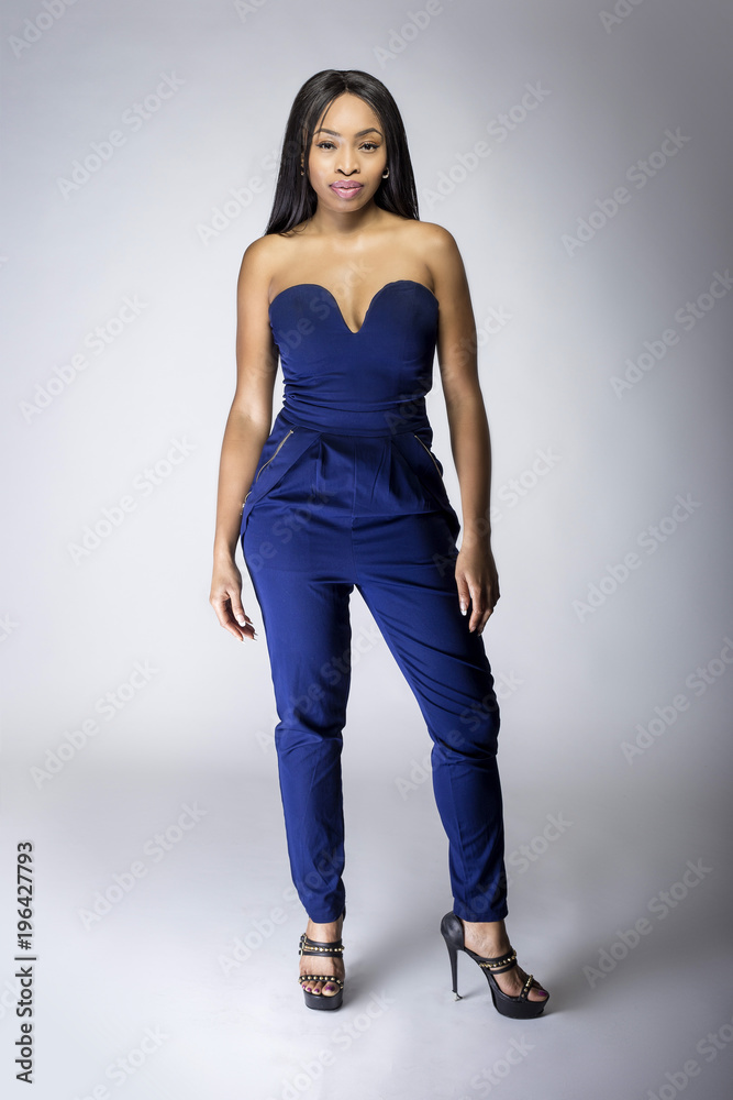 Sexy black female fashion model wearing apparel with blue pants. The outfit  is modern style for spring or summer clothing collection. The image depicts  trends in womenswear Photos
