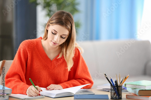 Pretty student studying at ...