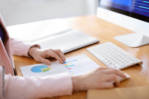 Woman working in office. Finance trading