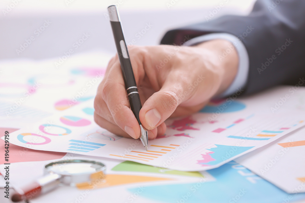 Man working with documents at table. Forex concept Man working with documents at table. Forex concept