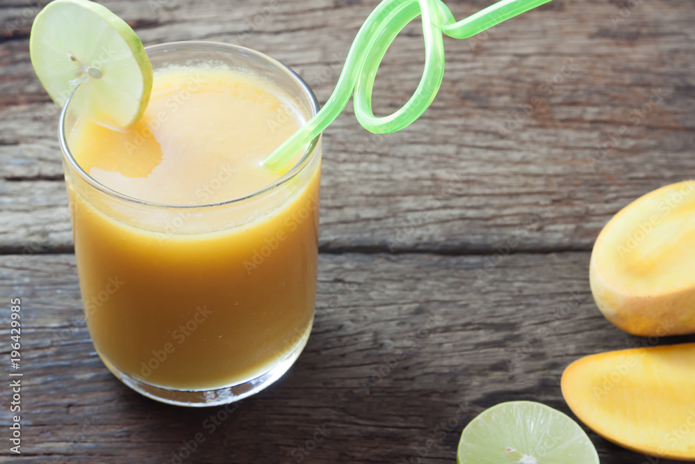 Fototapeta premium Summer drink, Tropical mango smoothie on wooden table, Summer holiday concept