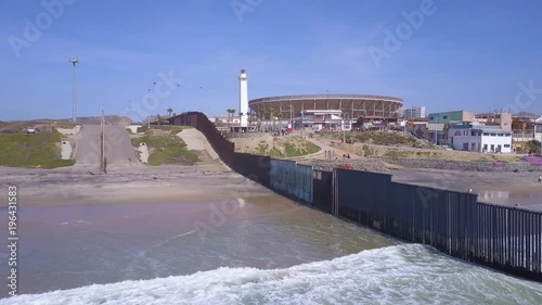 Good aerial of the U.S. Mexico border fence in the Pacific Ocean between San Diego and Tijuana. photo