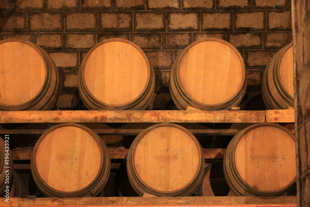 Wine barrels stacked in the cellar of the winery