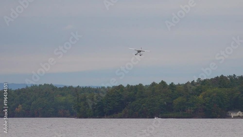 A seaplane lands on a lake in Maine. photo